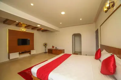 a bedroom with a large bed and a flat screen tv at Heavenly Hills 4 BHK Villa - 1 Bedroom in Kotagiri