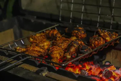 a tray of chicken and other food cooking on a grill at Heavenly Hills 4 BHK Villa - 1 Bedroom in Kotagiri