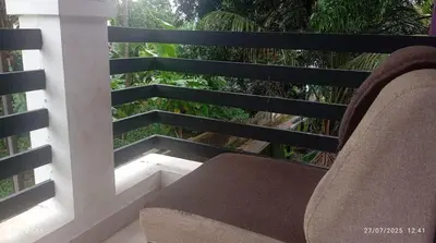 a bench sitting on a balcony with a view at Mannath Home Stay in Alwaye