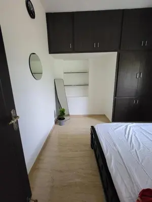 a bedroom with black cabinets and a bed in it at Serene Steps in Coimbatore