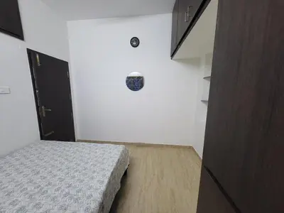 a bedroom with a bed in a white room at Serene Steps in Coimbatore
