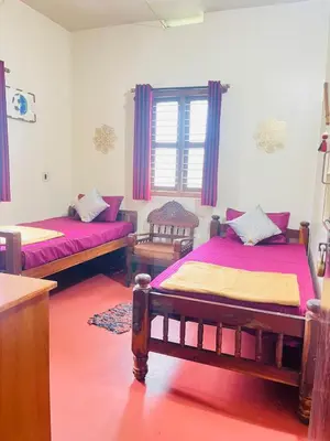 a room with two beds and a window at Quiet quarters Estate Stay in Napoklu