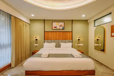 a bedroom with a large bed in a room at Hotel Urban Bella in Kozhikode