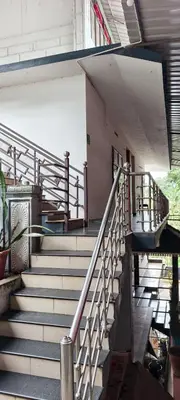 a set of stairs in front of a building at Banasura Green paradise , Villa , Deluxe rooms , Budget rooms in Padinjarathara