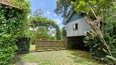 a house with a fence next to a yard at Pearl Spot in Alwaye