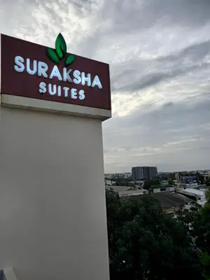 a sign on the side of a building at Suraksha Suites in Mysore
