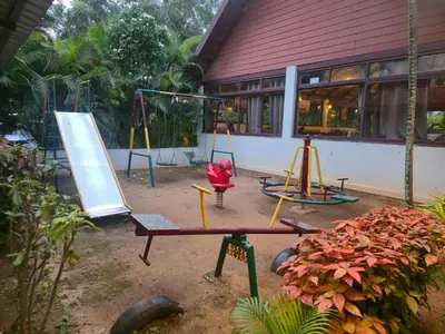 a playground with two swings and a swing at Suraksha Suites in Mysore