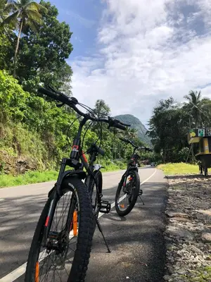 two bikes parked on the side of a road at Nature's nest in Kuttampuzha