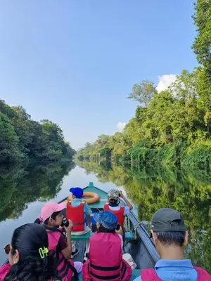 a group of people in a boat on a river at Nature's nest in Kuttampuzha