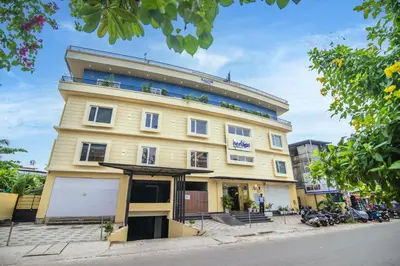 a large yellow building on the side of a street at Neelagiri Heritage Hotel in Kozhikode