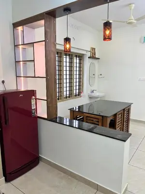 a kitchen with a red refrigerator and a sink at Ayat Apartments - near to Rajagiri Hospital in Alwaye