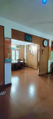 a lobby with a clock on the wall and a door at Tejana villa in Mananthavady