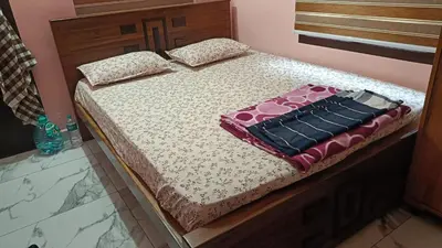 a bed in a bedroom with a bedvisor with a purse on it at Full Home Wayanad Bathery in Sultan Bathery
