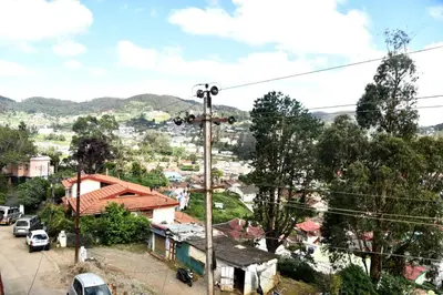 a view of a town with a cross on a pole at Mountain Villa Ooty Rooms in Ooty