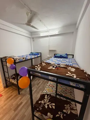 a room with two bunk beds in it at AAN GREENS Rooms And Dormitorys in Vaduvanchal