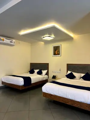two beds in a hotel room with two bedsvisor at Pakalakam Resorts in Cheruppulasseri