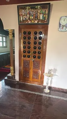 a wooden wine cellar with a bunch of wine bottles at Lakshminarayanappa Niwasa in Channapatna