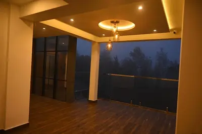 an empty balcony with a view of the woods at Boulevard Premium Luxury Hotel in Munnar