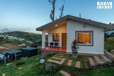 a small house on top of a hill at StayVista at Rustling Pine with Bonfire, BBQ & Lawn in Ooty