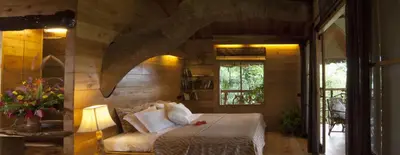 a bedroom with a bed and a window in a room at Tranquil Resort - Blusalzz Collection, Wayanad - Kerala in Ambalavayal