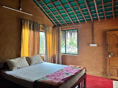 a bedroom with a bed and a window at Mannora Resorts Marayoor in Marayoor