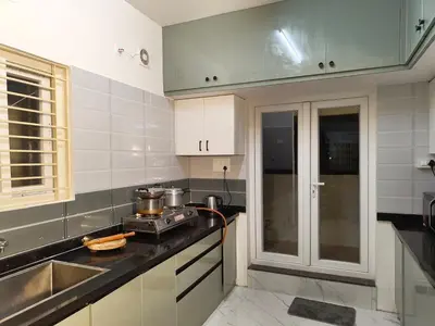a kitchen with a sink and a counter top at Luxurious 3BHK AC, Peaceful location, Premium stay in Mysore