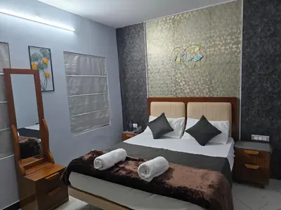 a bedroom with a bed with pillows and a mirror at Nest Resort in Ketti