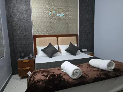 a bedroom with a large bed with towels on it at Nest Resort in Ketti
