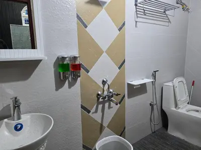 a bathroom with a sink and a toilet at Nest Resort in Ketti