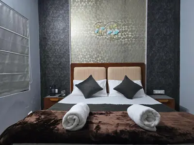 a bedroom with a bed with towels on it at Nest Resort in Ketti