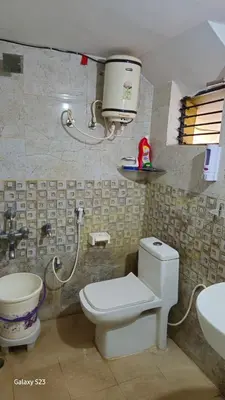 a bathroom with a toilet and a sink at JEO Home Stay And Hospitality in Mysore
