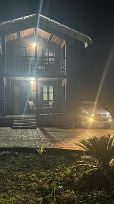 a car parked in front of a house at night at Coorg Namana homestay in Suntikoppa