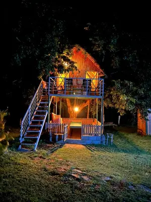 a house with a staircase in a yard at night at bandipur stay in Tāmarakarai