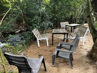 a group of chairs and tables sitting in the dirt at bandipur stay in Tāmarakarai