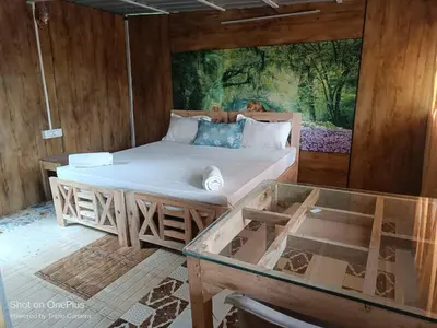 a room with a bed and a glass table at Ashokavanam Heritage Village by N Square in Kanthalloor