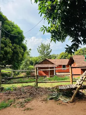 a house with a fence in front of it at Jungle Homes in Kollengode