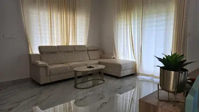 a living room with a couch and a table at Casa Bella - The Group Stay in Sultan Bathery