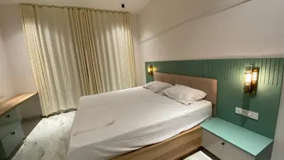 a small bedroom with a bed and a green wall at Casa Bella - The Group Stay in Sultan Bathery