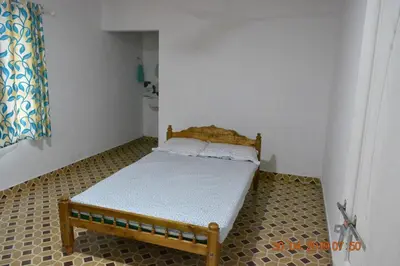 a small bedroom with a bed in the corner at Jungle View Homestay Anakulam in Viripara