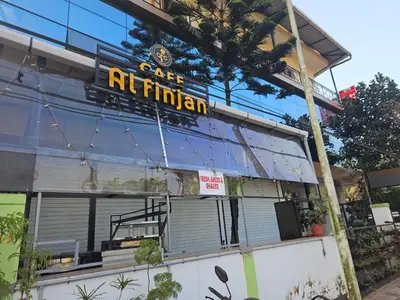 a restaurant with a sign on the side of a building at RF Tower in Kozhikode
