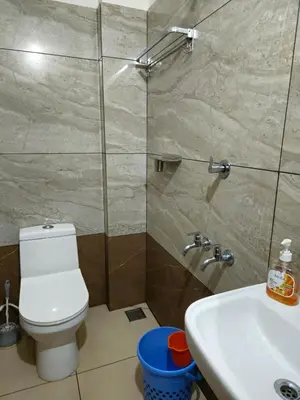 a bathroom with a toilet and a sink at RF Tower in Kozhikode