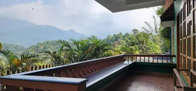 a balcony with a view of the mountains at Wayanad views in Vythiri