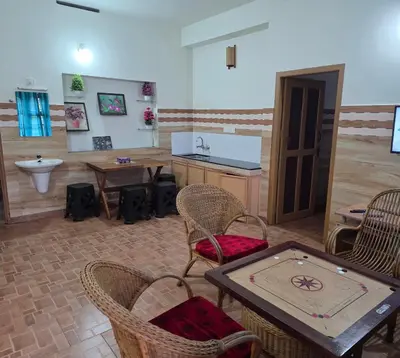 a room with a table and chairs and a sink at Wayanad views in Vythiri