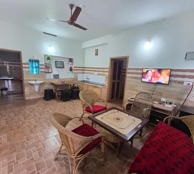 a living room with a table and chairs at Wayanad views in Vythiri