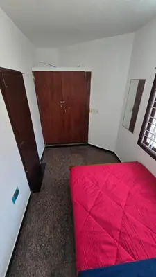 a bedroom with a red bed in a room at Nature View Private Villa in Ooty