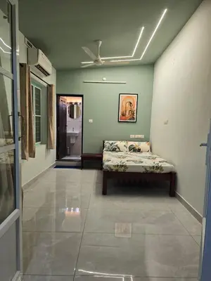 a bedroom with a bed and a ceiling fan at Rivulet Dale in North Paravur