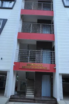 a building with a sign that reads sengoku service requirements at Brindavan Service Apartments in Mysore