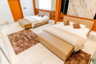 a bedroom with two beds and a couch at AE Tower Platinum Retreat in Sultan Bathery