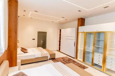 a bedroom with two beds and a closet at AE Tower Platinum Retreat in Sultan Bathery