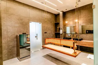 a bathroom with a wooden bench in a room at AE Tower Platinum Retreat in Sultan Bathery